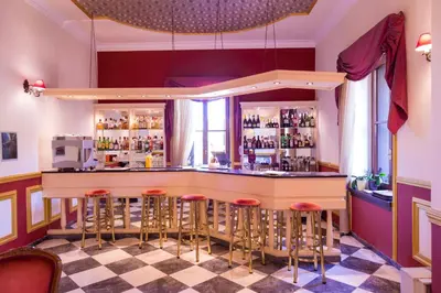 a bar in a restaurant with bar stools at Halepa Hotel in Chania Town