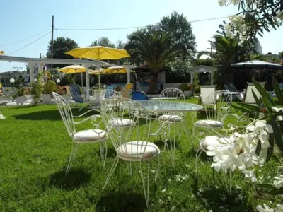 a group of chairs and a glass table in the grass at Sun City in Kato Daratso
