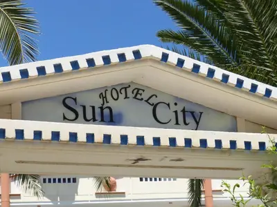 a sign for aotelegate sun city on top of a building at Sun City in Kato Daratso
