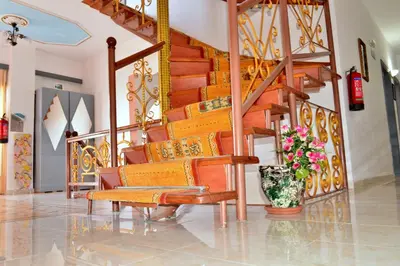 a lobby with a staircase and a vase of flowers at Sun City in Kato Daratso