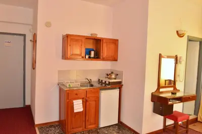 a kitchen with wooden cabinets and a sink at Sun City in Kato Daratso