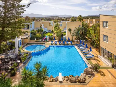 an overhead view of a swimming pool with lounge chairs at Futura Hotel in Maleme