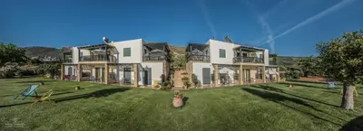 a large house with a large yard with grass at Magnolia Apartments and Studios in Falasarna