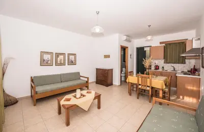 a living room with a couch and a table at Magnolia Apartments and Studios in Falasarna