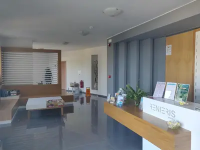 a lobby with a reception desk in a building at Renieris Hotel in Stalos