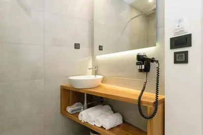 a bathroom with a sink and a mirror at Renieris Hotel in Stalos