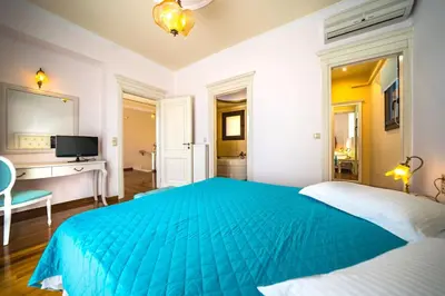 a bedroom with a blue bed and a desk at Iro Royal Villa by PosarelliVillas in Dhémbla
