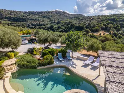 an overhead view of a swimming pool with chairs and trees at Villa Lucy by PosarelliVillas in Plataniás