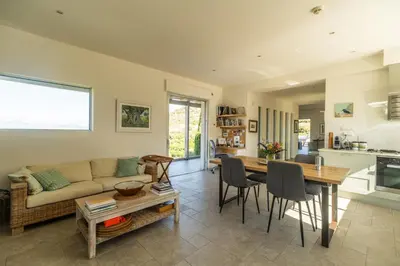 a living room with a couch and a table at Villa Lucy by PosarelliVillas in Plataniás