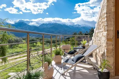a balcony with chairs and a view of mountains at Stone villa Halepa panoramic view, private pool,big garden & quiet in Néon Khoríon