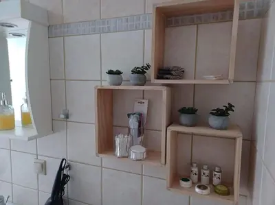 a kitchen with wooden shelves and potted plants on the wall at Mini Villa Kalathas in Kalathas