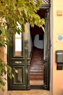 an entrance to a green door with a staircase at Silde Studios & Apartments in Chania Town