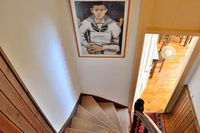 a painting of a man on a wall next to a staircase at Silde Studios & Apartments in Chania Town