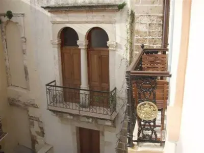 a building with a wooden door and a balcony at Silde Studios & Apartments in Chania Town