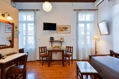 a living room with a bed and a table and chairs at Silde Studios & Apartments in Chania Town