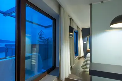 a room with a large window and a view of the ocean at Frideriki Studios & Apartments in Plataniás