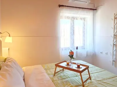a room with a bed and a table with flowers on it at Enastron vacation house in Kissamos
