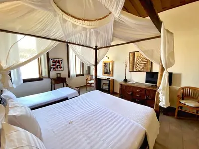 a bedroom with a canopy bed and a desk at Boutique Hotel Del Doge in Chania Town