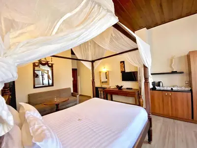 a bedroom with a white canopy bed and a desk at Boutique Hotel Del Doge in Chania Town