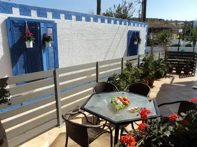 a table with a bowl of fruit on a patio at The Getaway in Agia Marina Nea Kydonias