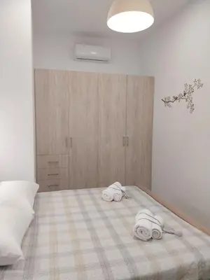 a bedroom with a bed with two towels on it at The Getaway in Agia Marina Nea Kydonias