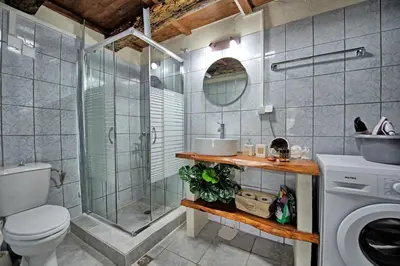 a bathroom with a shower and a toilet and a sink at Aretousa by PosarelliVillas in Dhrakóna