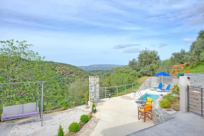 a house with a balcony with a swimming pool at Aretousa by PosarelliVillas in Dhrakóna