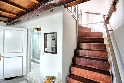 a staircase in a house with wooden ceilings at Aretousa by PosarelliVillas in Dhrakóna