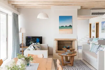 a living room with a couch and a fireplace at Falasarna Luxury Villas I Private 
