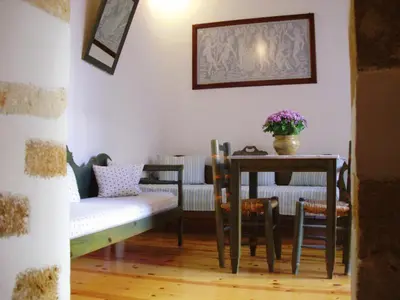 a dining room with a table and a table and chairs at Madonna Studios in Chania Town