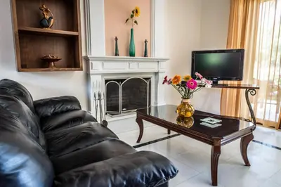 a living room with a leather couch and a coffee table at Erodios Villas 2 in Ptinotrofíon