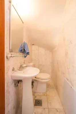 a bathroom with a sink and a toilet and a mirror at Erodios Villas 2 in Ptinotrofíon