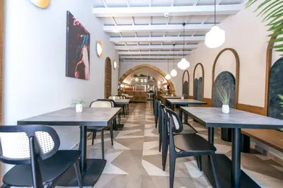 a row of tables and chairs in a restaurant at El Greco Hotel in Chania Town