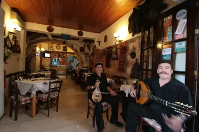 a man and a woman holding a guitar in a restaurant at Chania Rooms in Chania Town