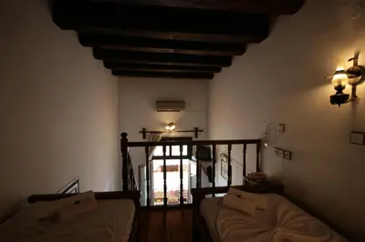 a living room with a couch and a stair case at Chania Rooms in Chania Town