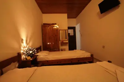 a room with two beds in a room at Chania Rooms in Chania Town