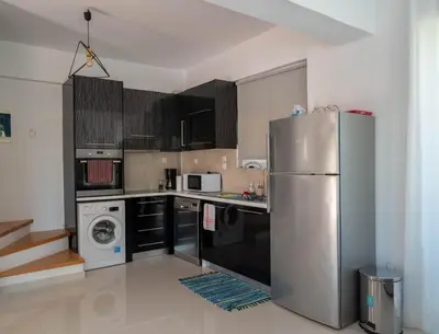 a kitchen with a stainless steel refrigerator and appliances at Villa Meltemi in Daratso