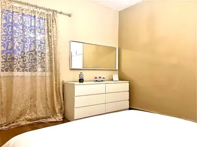 a bedroom with a dresser and a mirror at Odyseia Apts I at the center of the City & Old Town in Chania Town