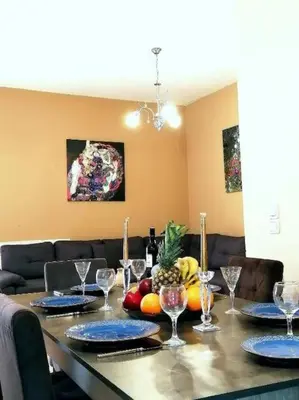 a table with plates and glasses on top of it at Odyseia Apts I at the center of the City & Old Town in Chania Town