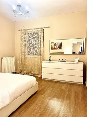 a bedroom with a bed and a dresser and a mirror at Odyseia Apts I at the center of the City & Old Town in Chania Town