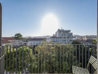 a balcony with two chairs and a view of a city at Arkadi Hotel in Chania Town