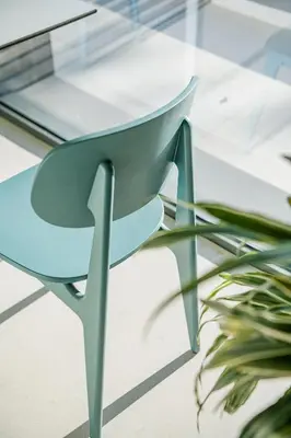 a blue chair sitting on top of a glass table at Arkadi Hotel in Chania Town