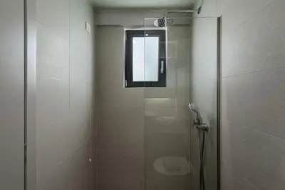 a shower with a glass door and a window at Arkadi Hotel in Chania Town