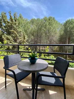 a table and chairs on a balcony with a view at Monte Vardia in Chania Town