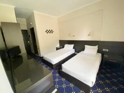 a hotel room with two beds and a mirror at Monte Vardia in Chania Town