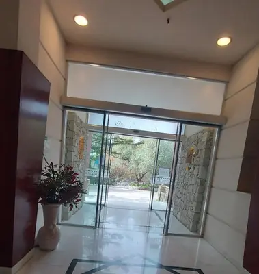 an entrance to a building with a large glass door at Monte Vardia in Chania Town