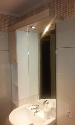 a bathroom with a sink and a large mirror at Alexandros Studios in Kalamaki Chanion