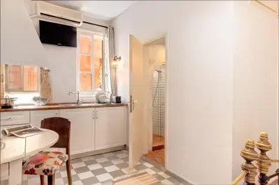 a kitchen with white cabinets and a sink at Pension Eva in Chania Town