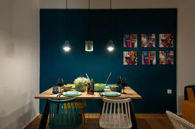 a dining room with a table with blue walls at Alsalos Sea View Apartment in Chania Town