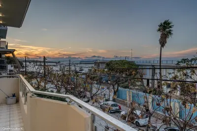 a balcony with a view of a parking lot with cars at Alsalos Sea View Apartment in Chania Town